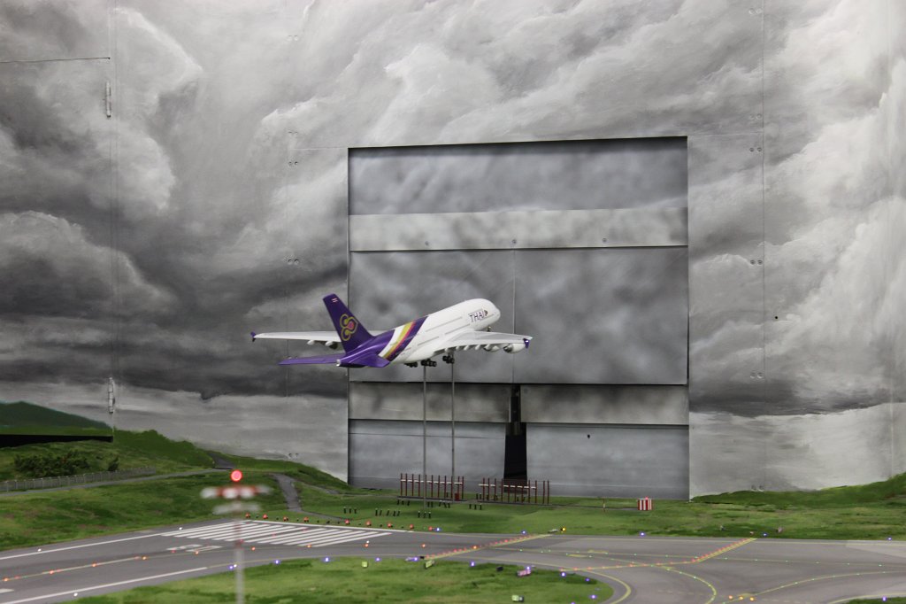 IMG_5884.JPG - Thai Airways A380 taking off in the  Miniatur Wunderland  ( miniature wonderland ). The world largest miniature railway not only host trains but also running cars, trucks, ship and even "flying" airplanes.