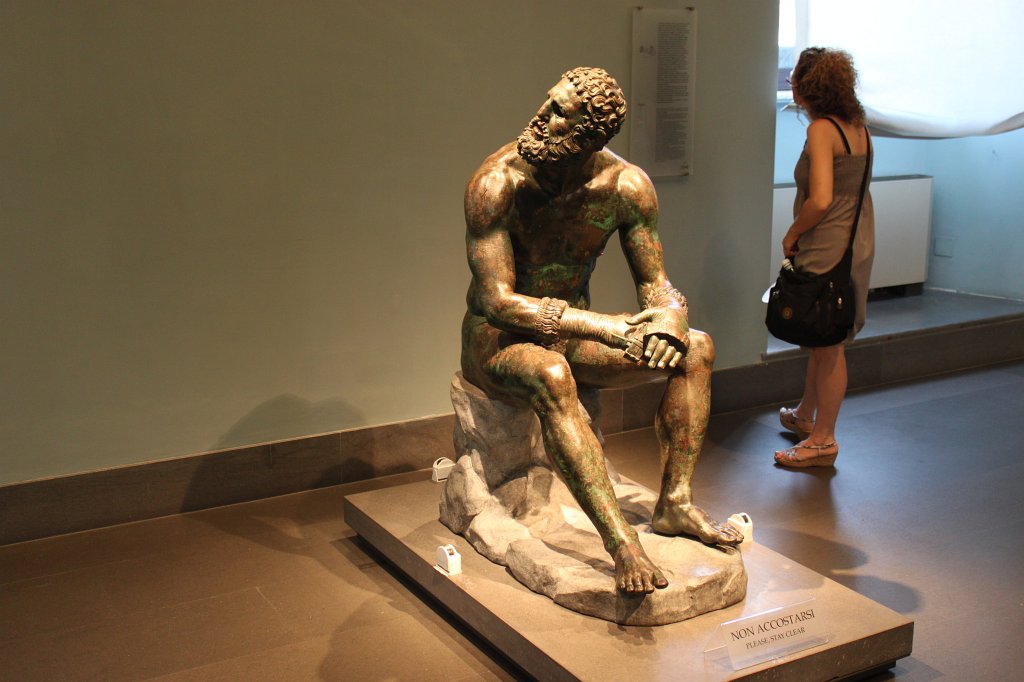 IMG_6728.JPG -  Boxer of Quirinal ,  Hellenistic Greek sculpture dated around 330 B.C. of a sitting nude boxer at rest still wearing his caestus on display at the  National Museum of Rome - Palazzo Massimo alle Terme 