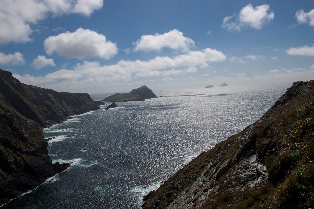 IMG_5514_c.jpg - The Kerry Cliffs are not as crowded as the Cliffs of Moher. The incoming waves change the colors of the water from deep blue to white. In the distance are the  Skellig Islands . The rightmost one is  Skellig Michael  which is known for its Christian monastery and recently as the filming location for the final scene of  Star Wars: The Force Awakens .