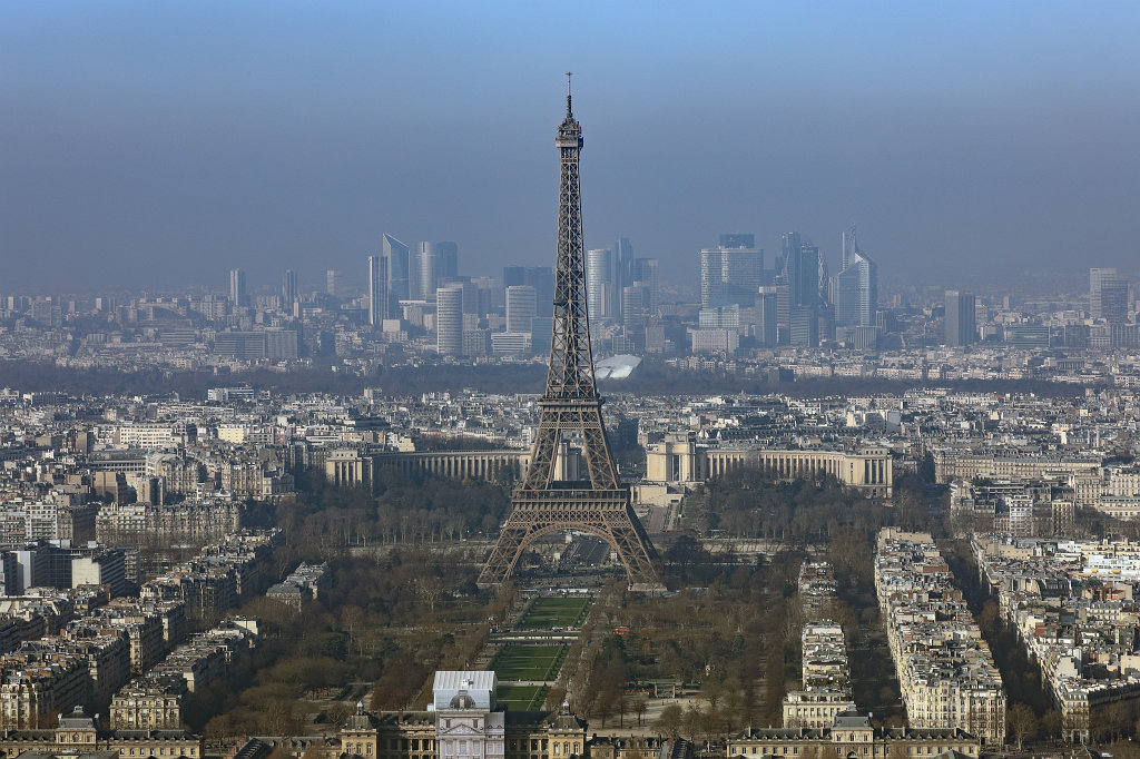 574B2085_c.jpg -  Tour Eiffel  on the  Champ de Mars  in  Paris ,  France . In the background are the skyscrapes of  La Défense . The view is from the  Tour Maine-Montparnasse  observation deck.